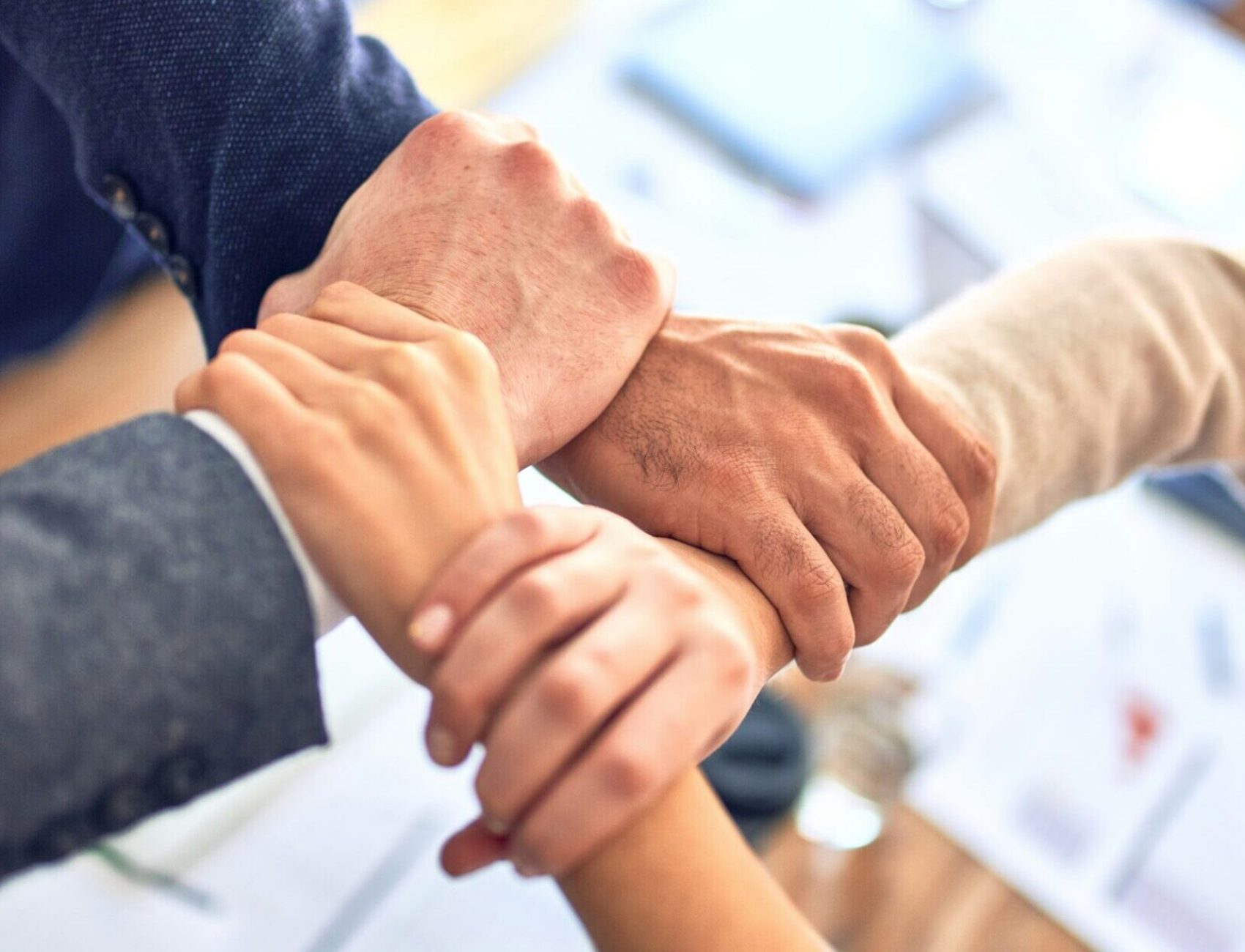 Team bonding by holding wrists.